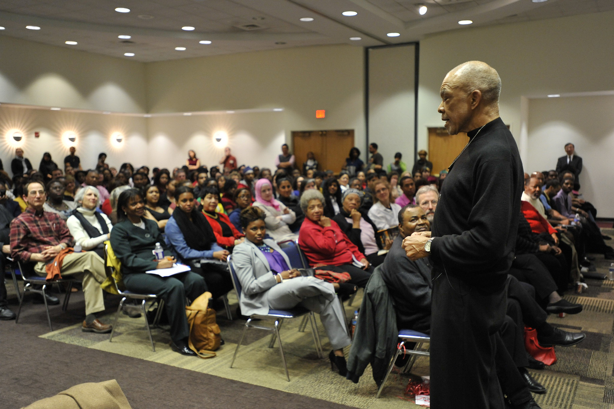 Tom Burrell walks through the audience as he speaks