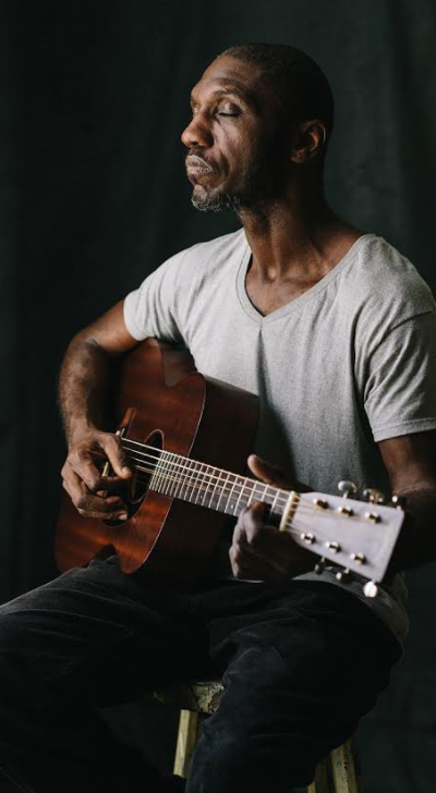 Cedric Burnside playing acoustic guitar