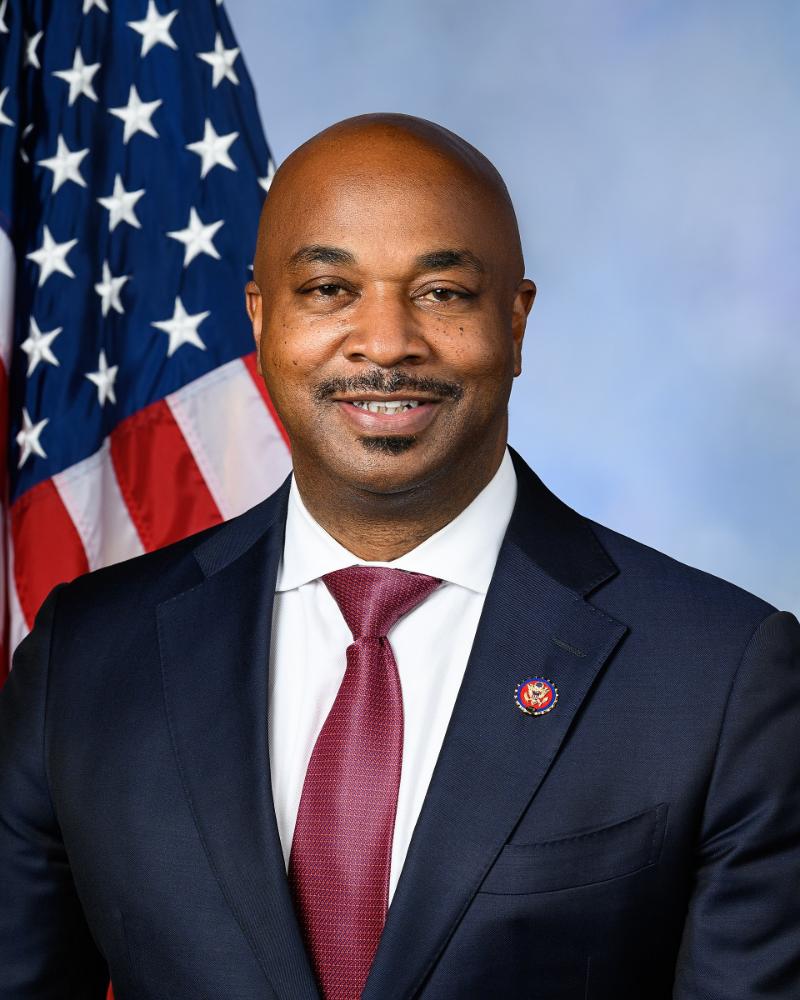 Rep. Kwanza Hall posing with American flag